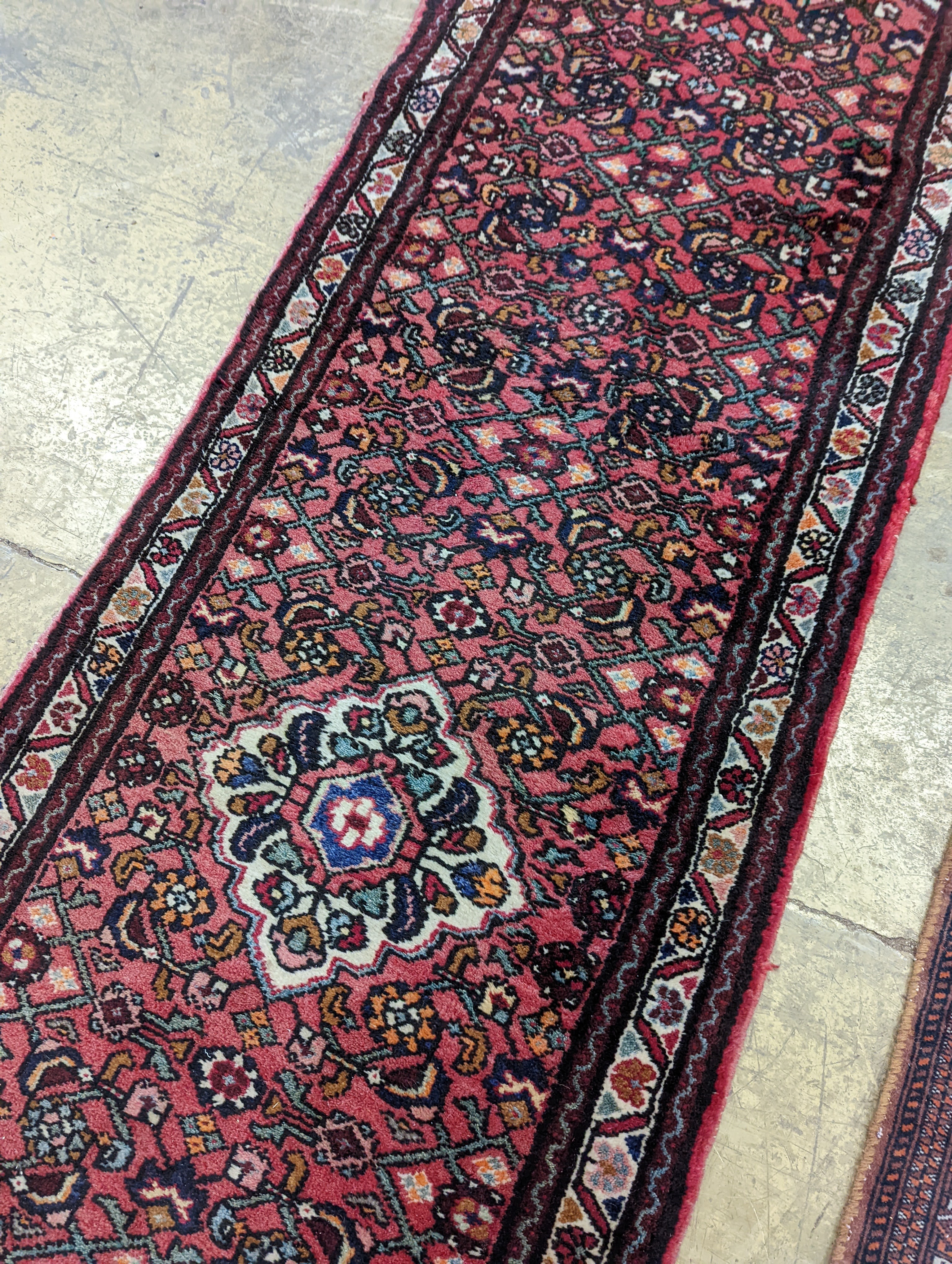 A North West Persian red ground runner and a Bokhara runner, larger approx. 290 x 78cm